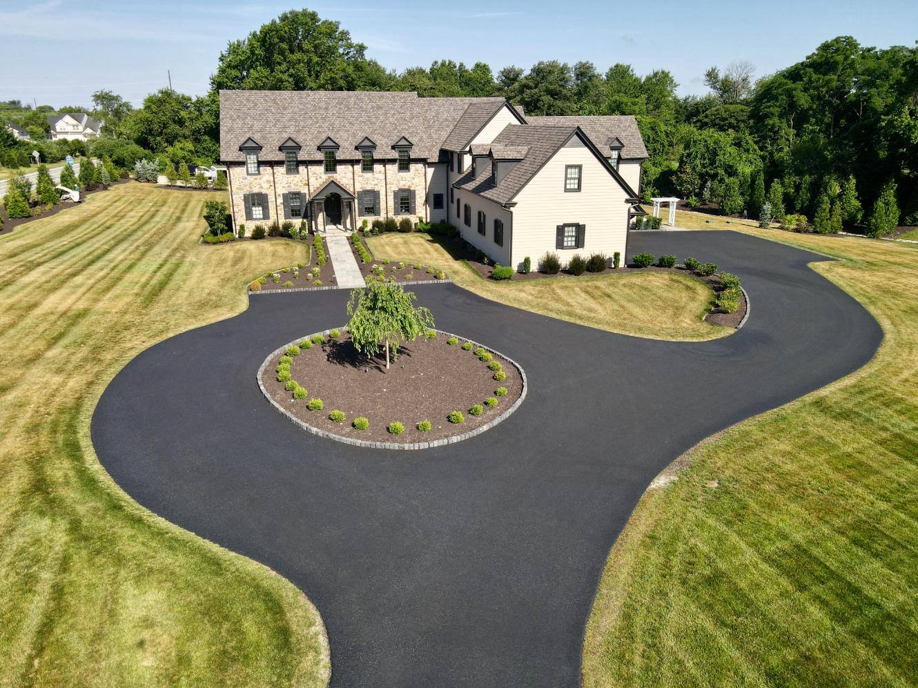 Aerial view of front of home driveway and walkway hardscaping and landscaping by First Class Lawn Care in Wilmington, DE