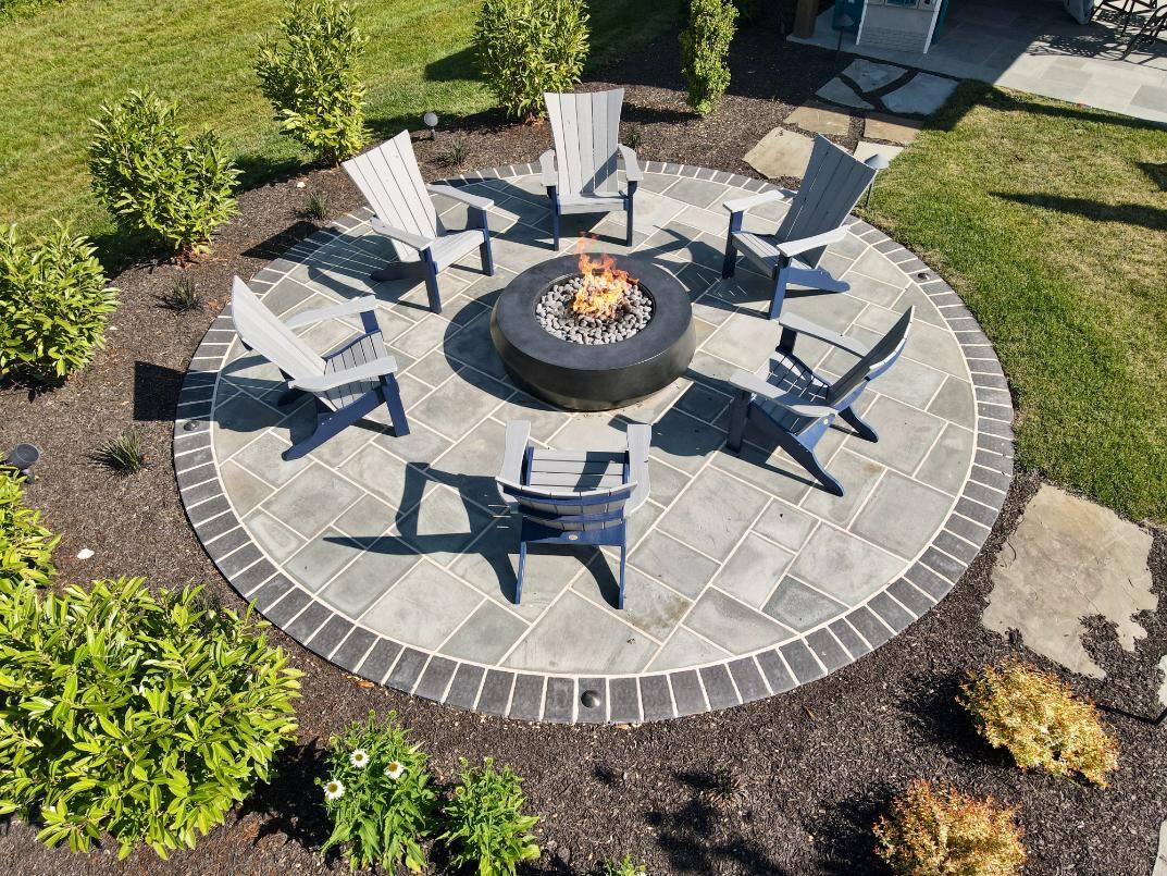 Aerial view of patio firepit and chairs hardscaping and landscaping by First Class Lawn Care in Wilmington, DE