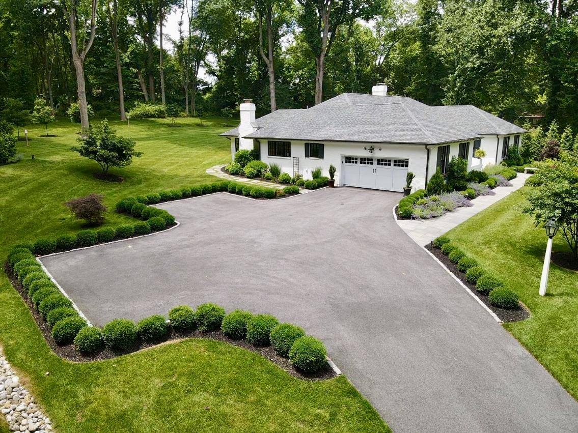Aerial view of side of home driveway hardscaping and landscaping by First Class Lawn Care in Wilmington, DE