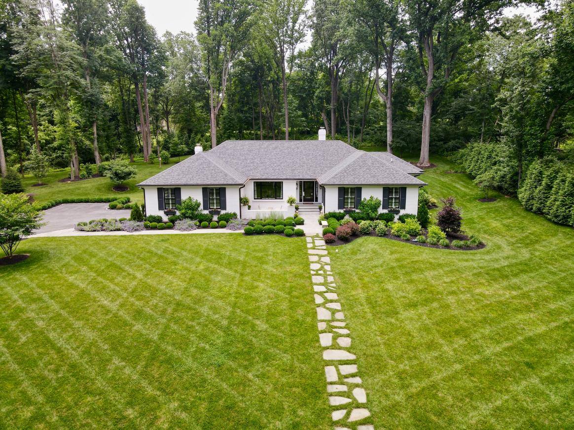 Aerial view of whole front yard landscaping and stone walkway by First Class Lawn Care in Wilmington, DE