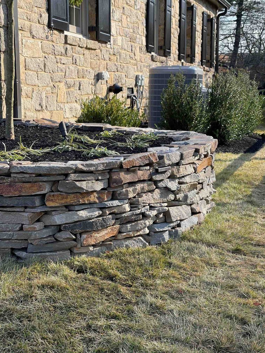 Circular Stone Flower Bed By First Class Lawn Care