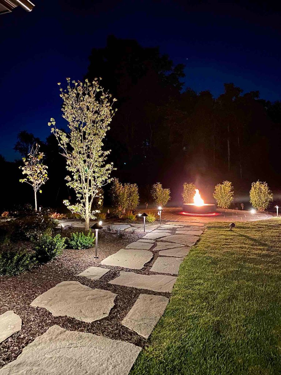 Custom Fire Pit with LED Lighting At Night by First Class Lawn Care