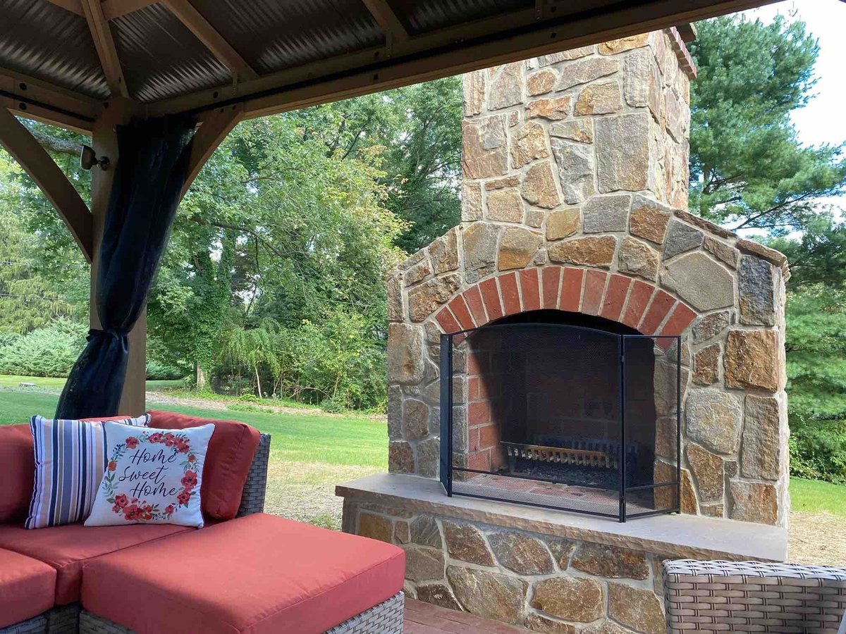 Custom Outdoor Fireplace with Covered Patio and Seating by First Class Lawn Care