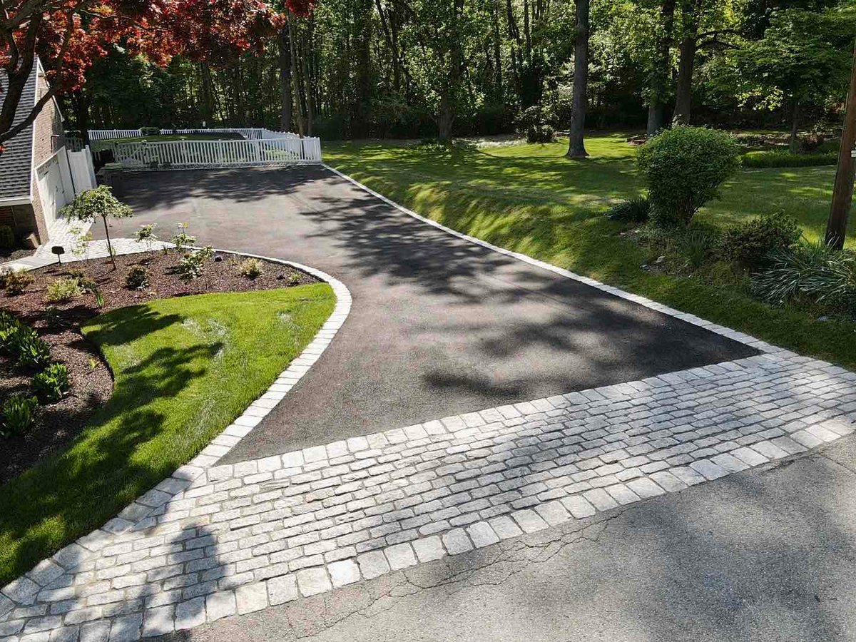 Driveway with Surrounding Landscaping and Hardscaping By First Class Lawn Care