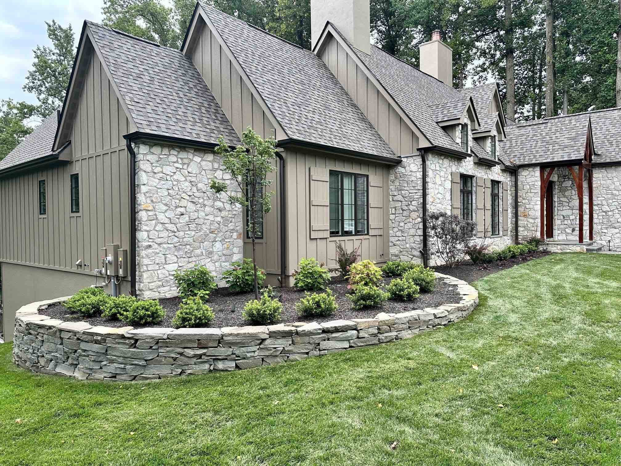 Hardscaped Circular Stone Flowerbed by First Class Lawn Care