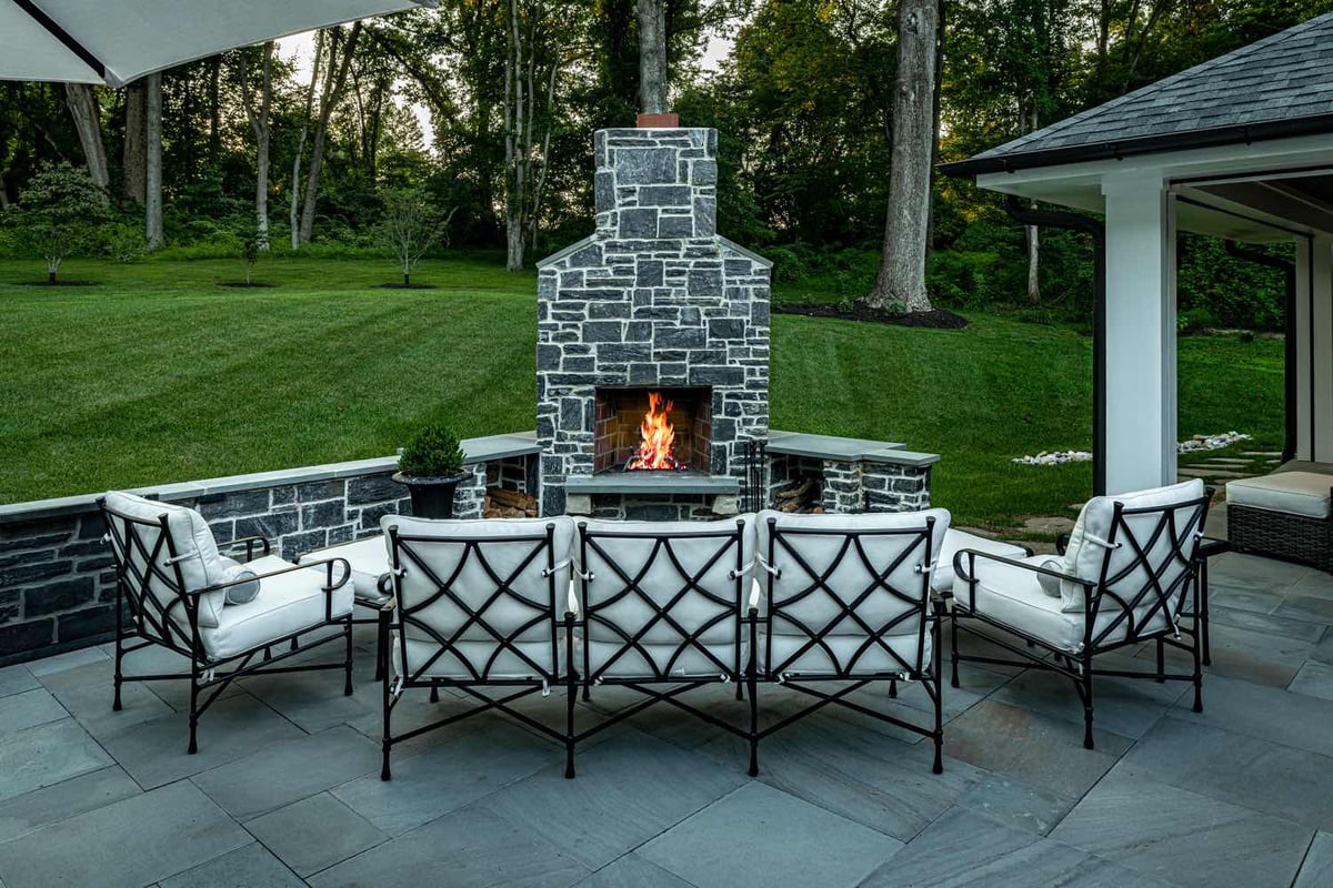 Outdoor Custom Stone Fireplace With Surrounding Seating By First Class Lawn Care