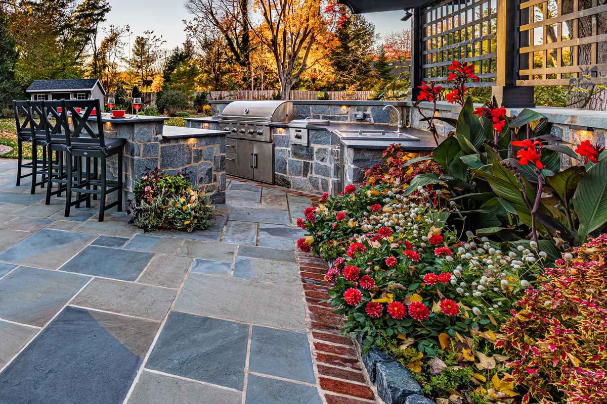 Outdoor Kitchen with Landscaping by First Class Lawn Care