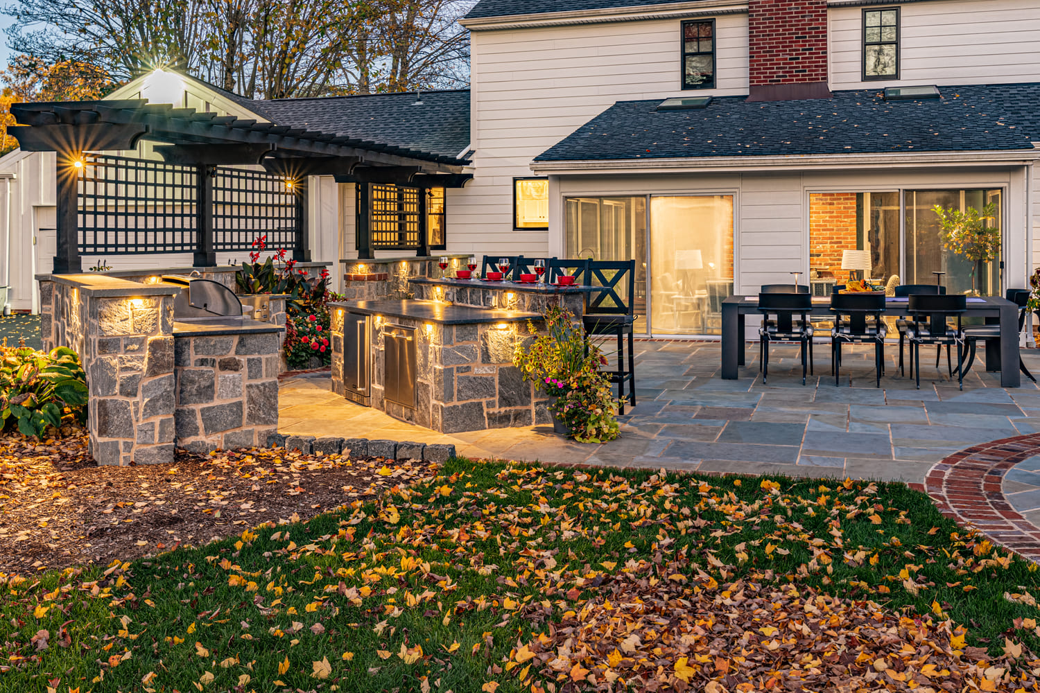 Custom Hardscaped Patio with Outdoor Kitchen by First Class Lawn Care
