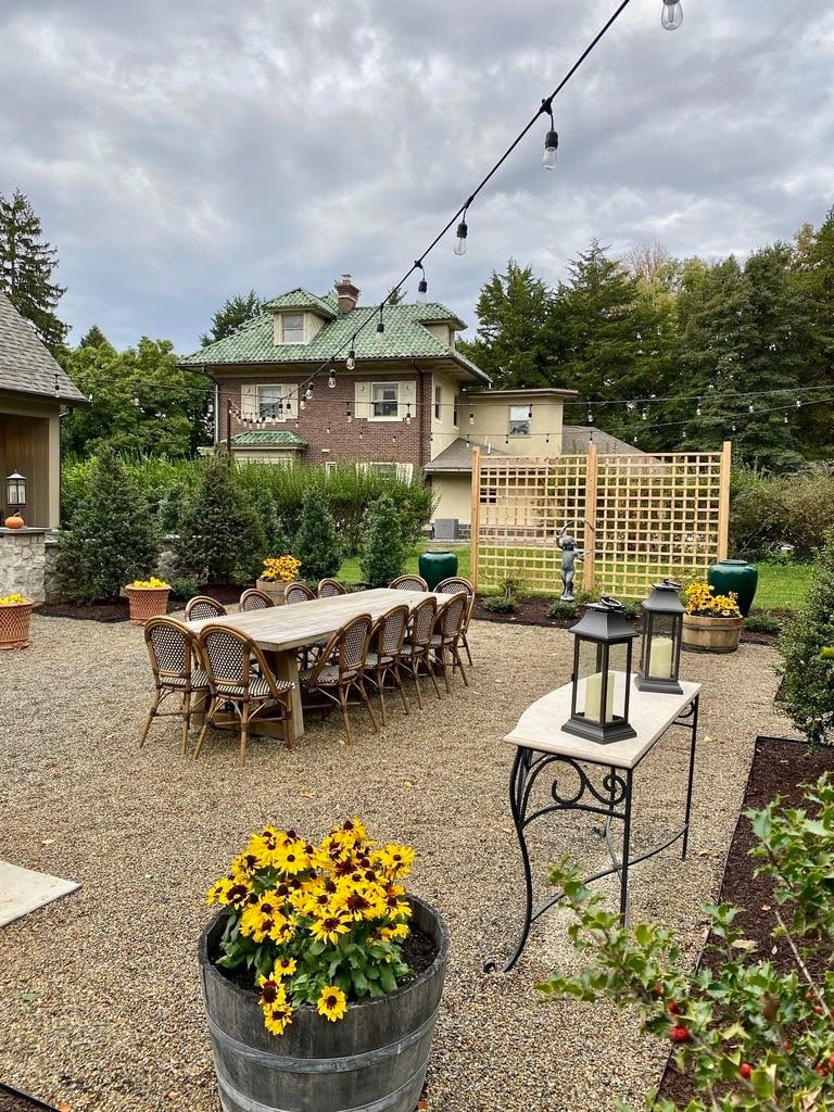 Custom Landscaped Outdoor Area With Table and Flowers by First Class Lawn Care