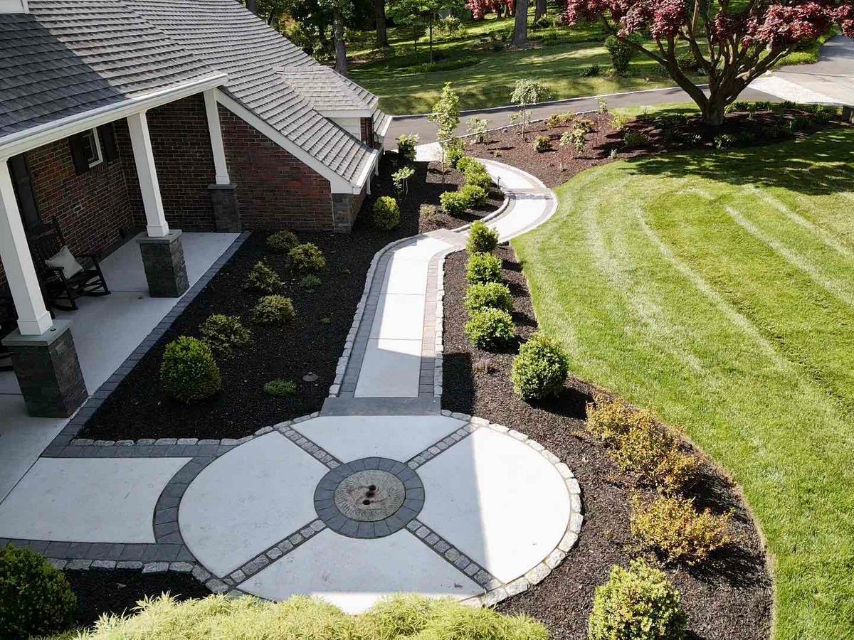 Custom Landscaping with Circular Patio by First Class Lawn Care