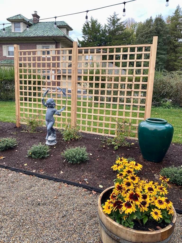 Custom Landscaping with Statue and Flowers by First Class Lawn Care