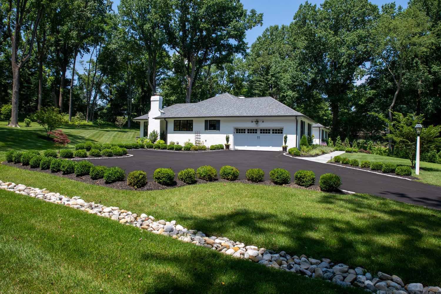 Custom Yard with Landscaping around Driveway by First Class Lawn Care