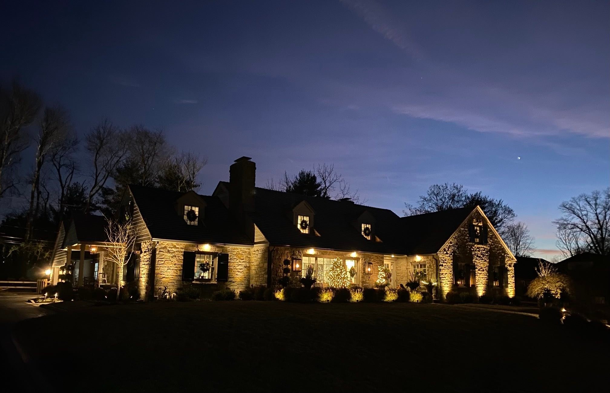 Side Yard View of Custom Landscaped & Lighting Lawn by First Class Lawn Care
