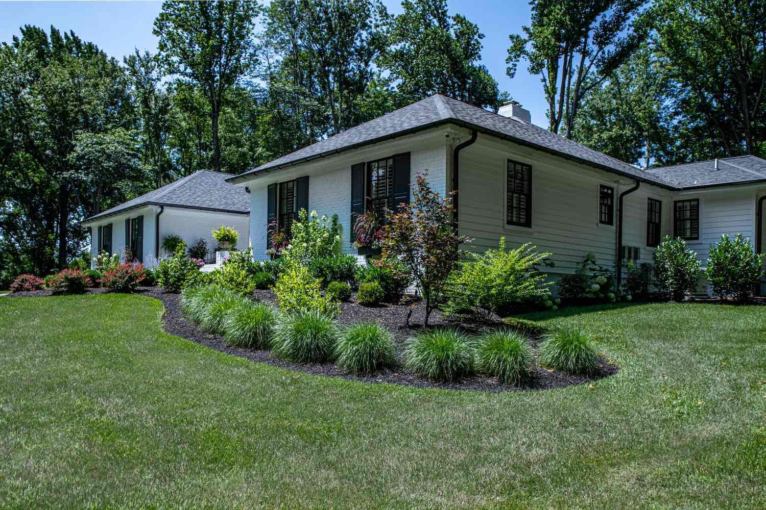 Side Of Home With Custom Landscaping by First Class Lawn Care