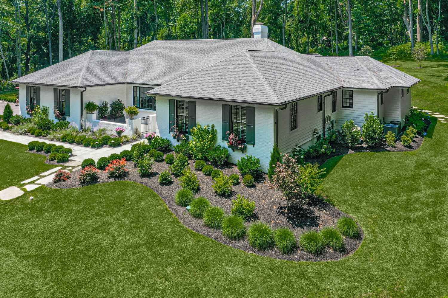 View Of Landscaping Around Whole Home by First Class Lawn Care