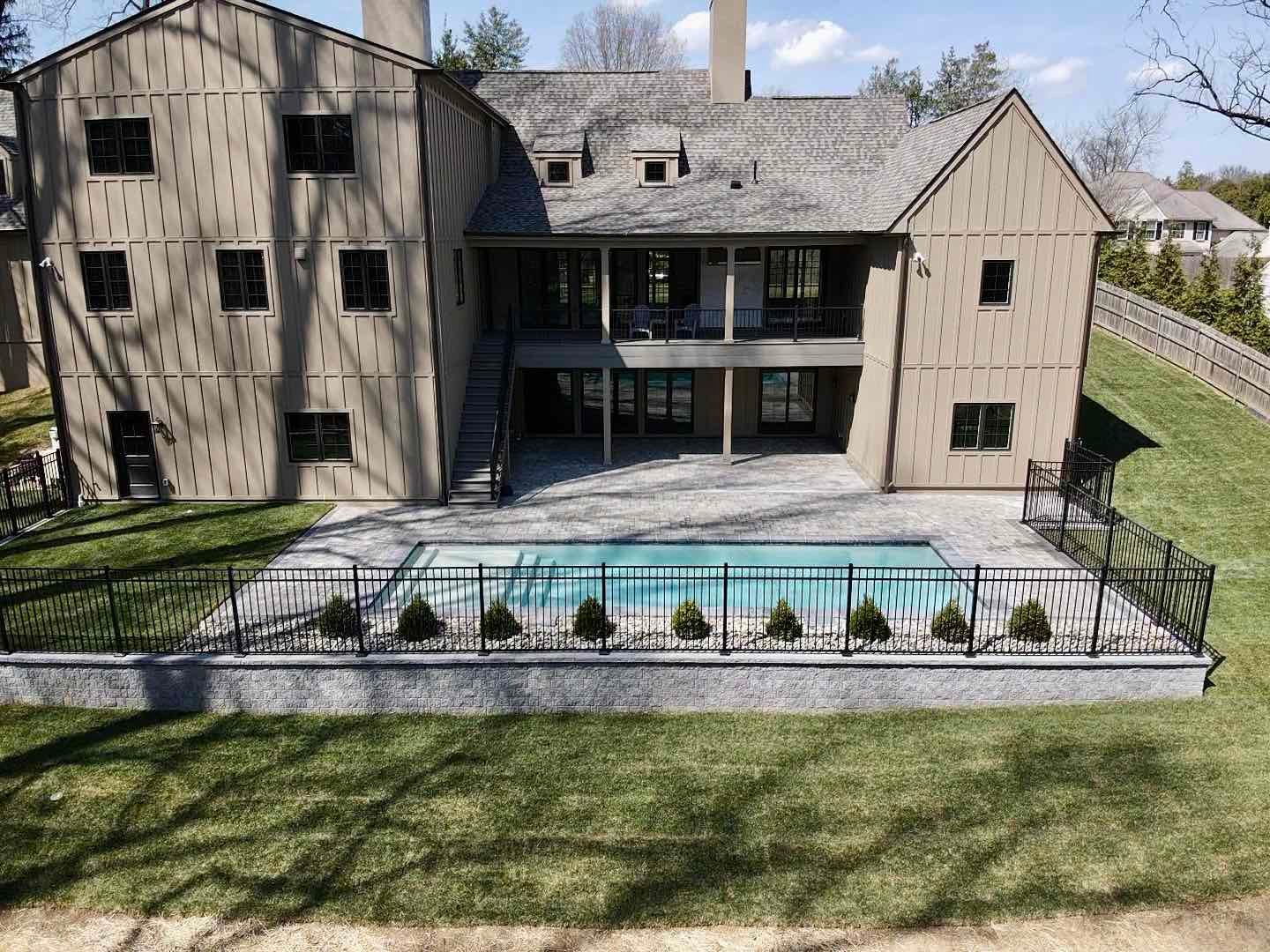 View of Yard With Inground Pool and Landscaping by First Class Lawn Care