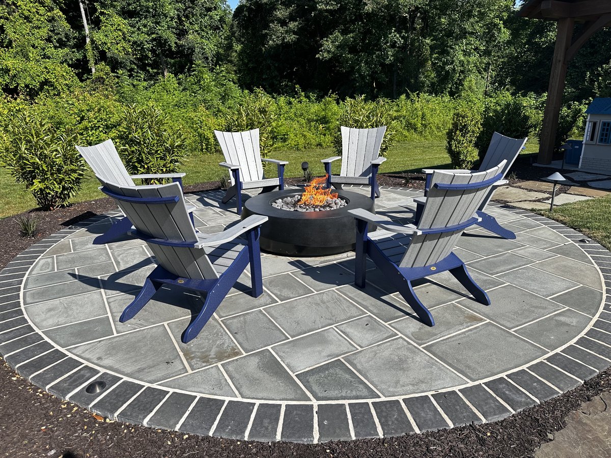 Side view of patio firepit sitting area by First Class Lawn Care in Wilmington, DE
