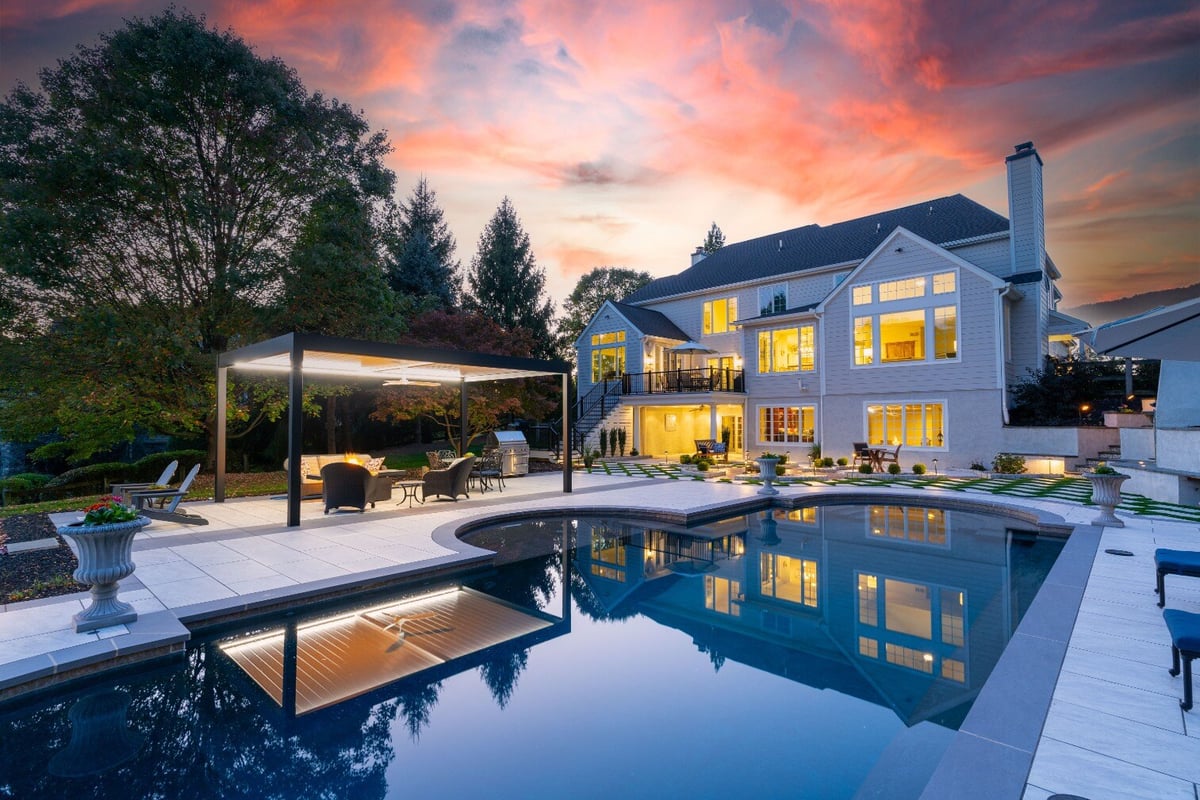 Stunning poolside patio with seating area and modern landscaping, hardscaping in West Chester, PA by First Class Lawn Care