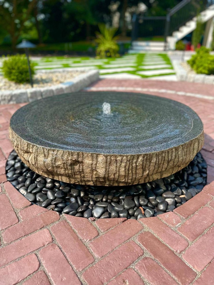 Water Fountain centered in english garden by First Class Lawn Care in West Chester, PA